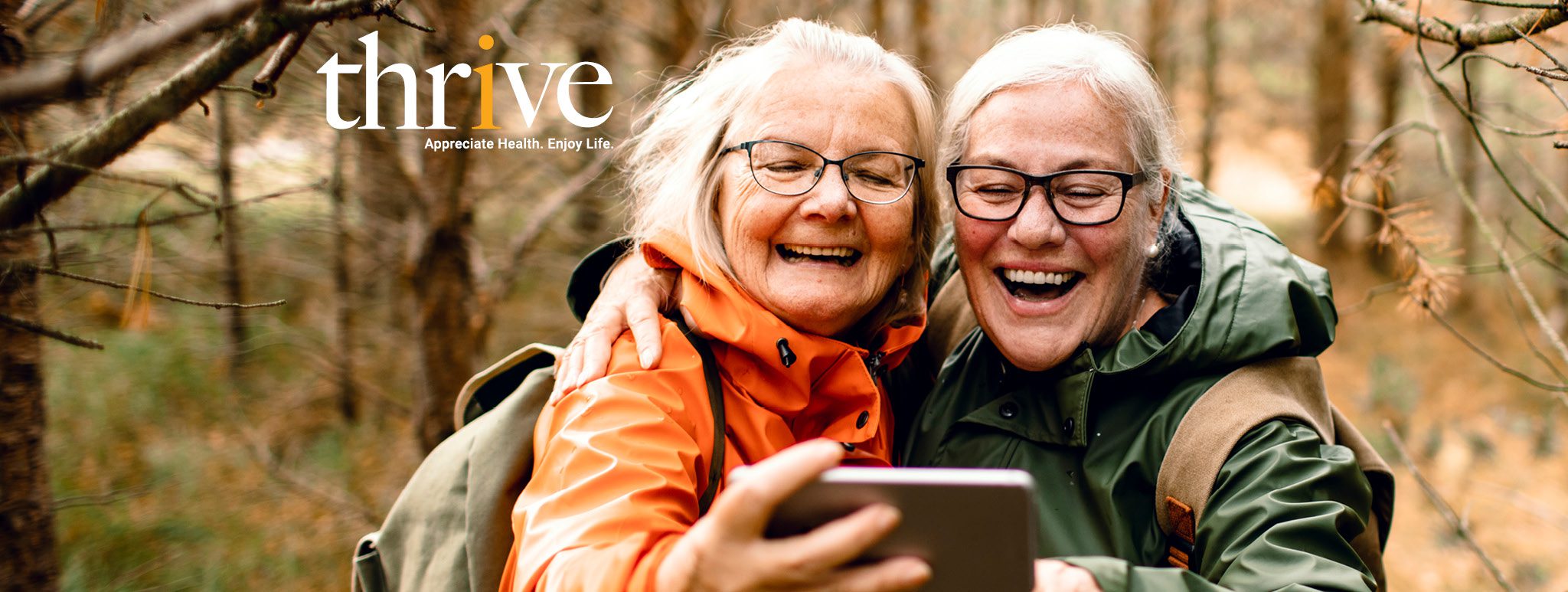 Two woman outside taking a selfie photo.